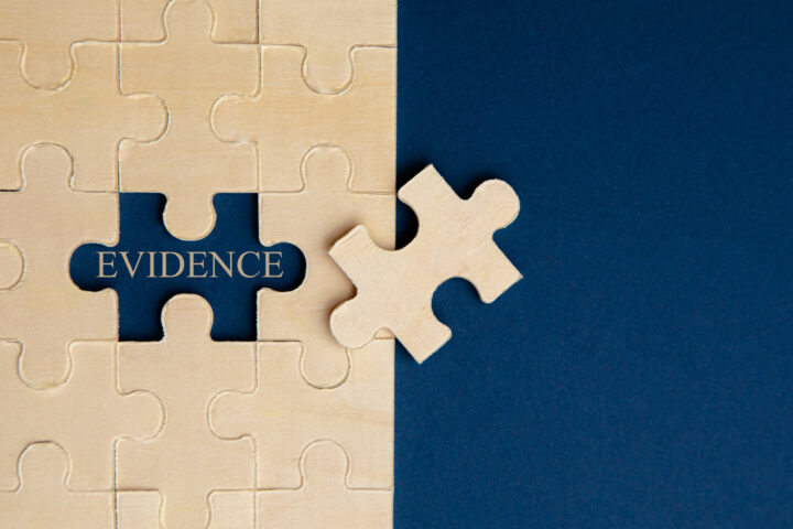 white puzzle pieces on a blue background that says evidence to indicate how to prove a car accident injury